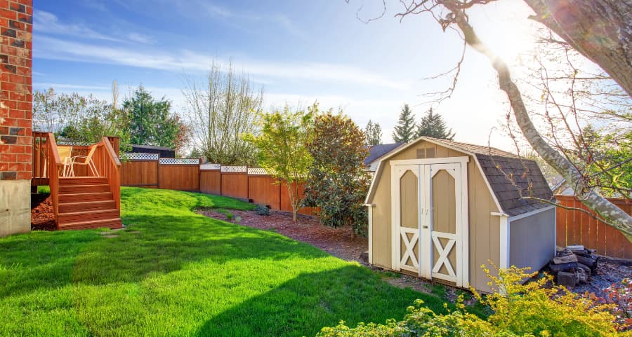 Fenced backyard with storage shed in Fargo